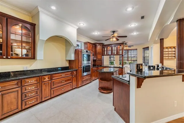 a kitchen with granite countertop a sink and a stove