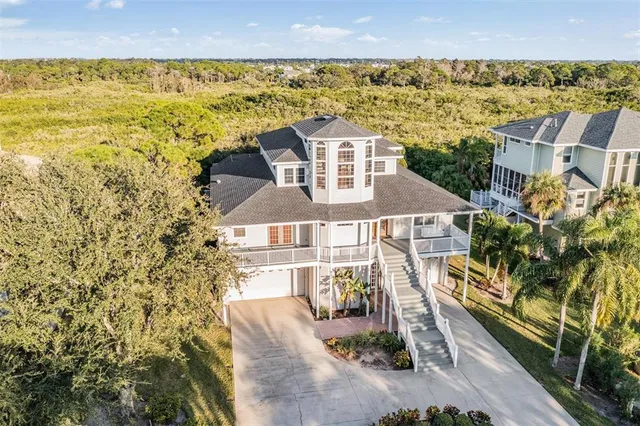 an aerial view of a house with a ocean view
