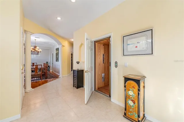 a balcony with wooden floor table and chairs