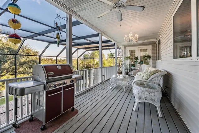 a view of a chairs and table in a patio with a barbeque