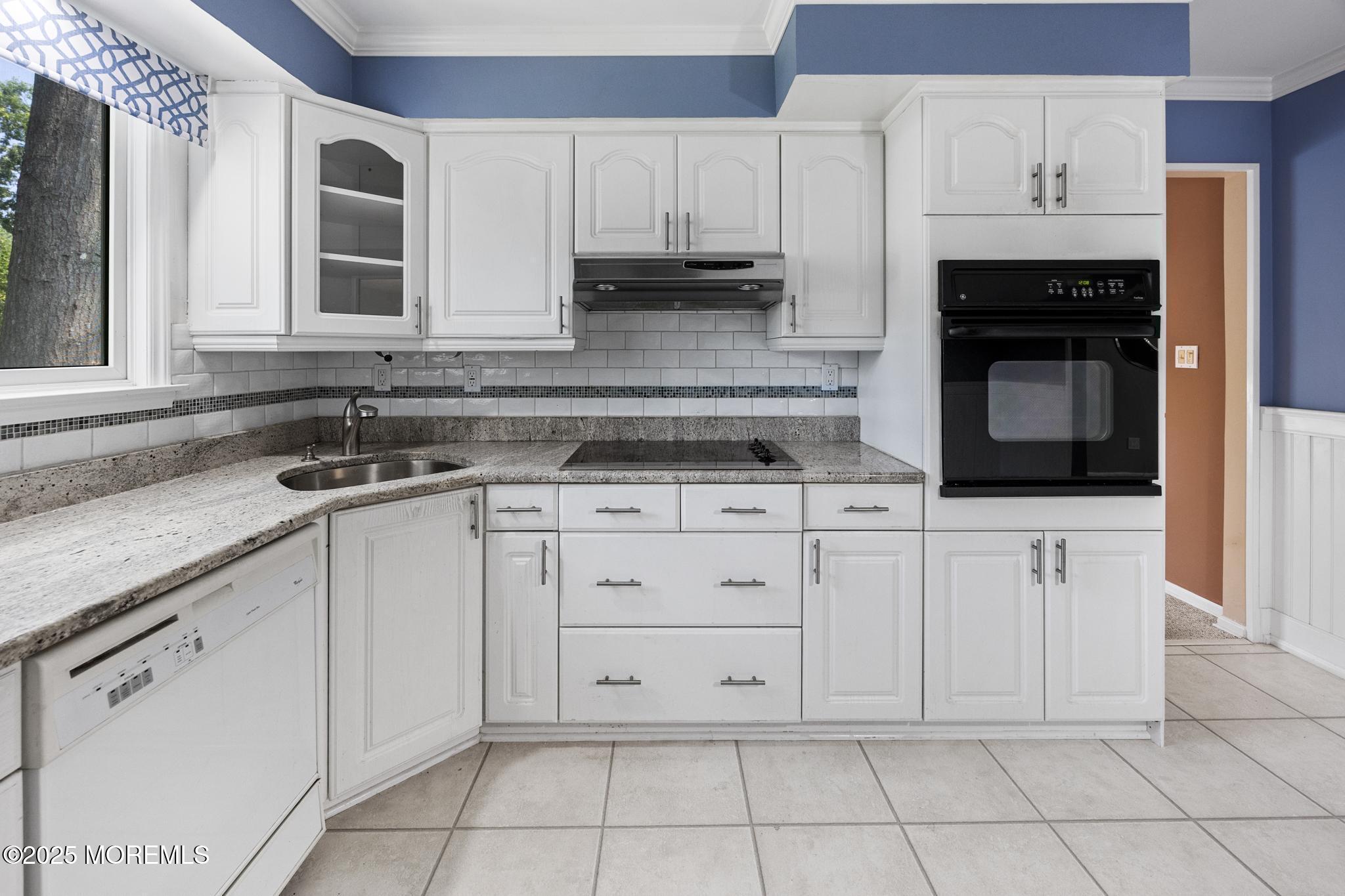 65 Pineland Road Brick, NJ 08724 - Photo 18 of 47 a kitchen with white cabinets and appliances