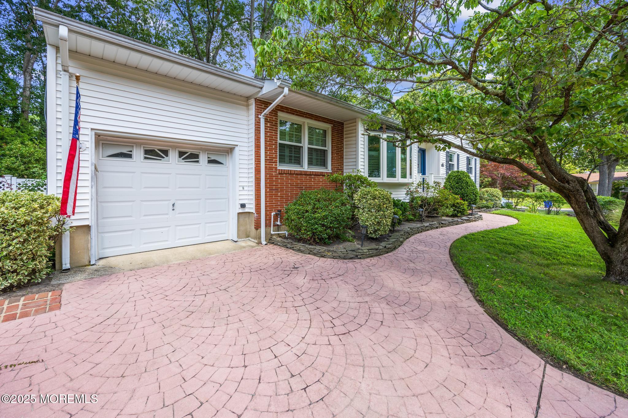 65 Pineland Road Brick, NJ 08724 - Photo 3 of 47 a front view of a house with a garden