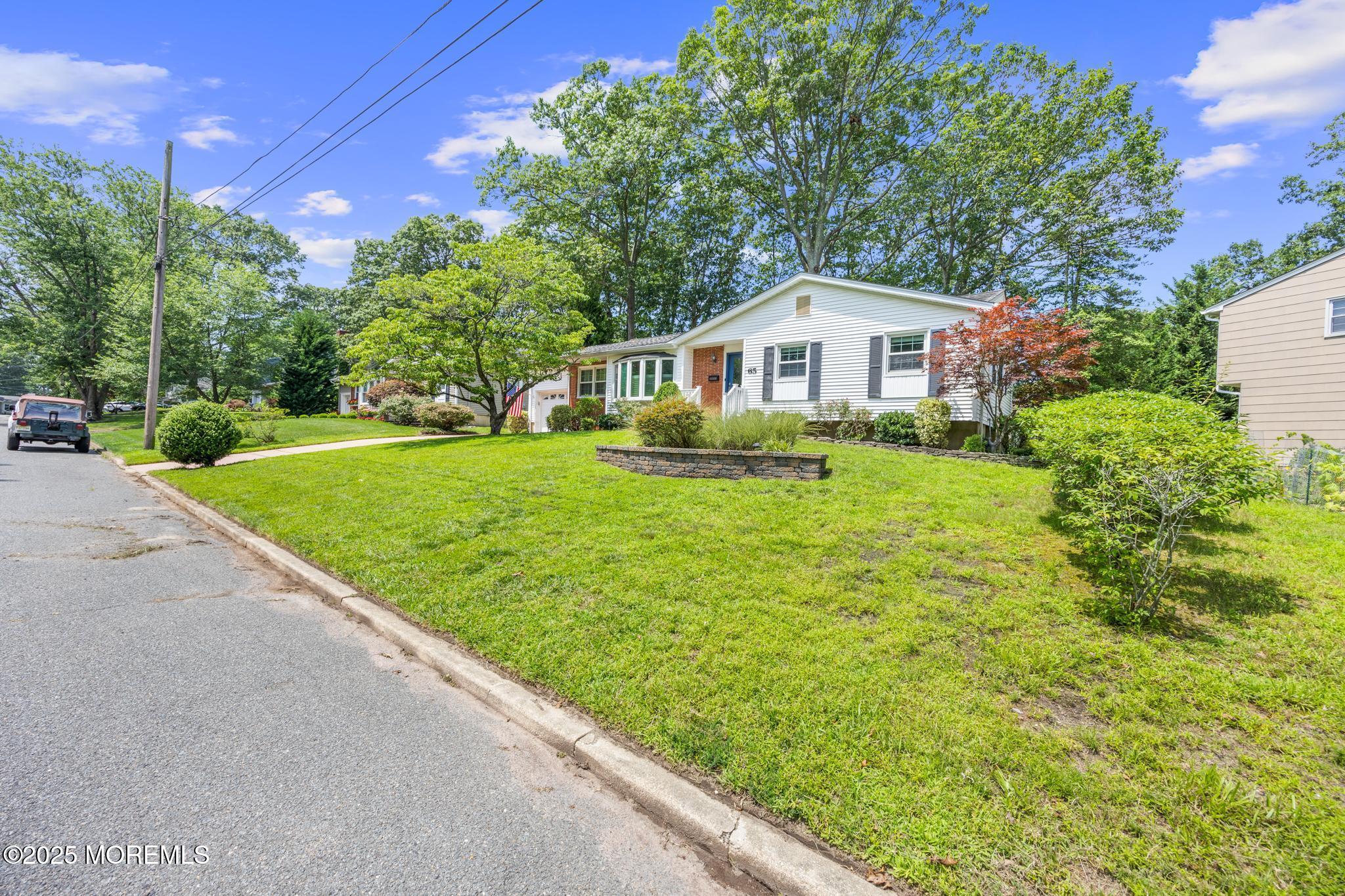 65 Pineland Road Brick, NJ 08724 - Photo 7 of 47 a front view of a house with a yard