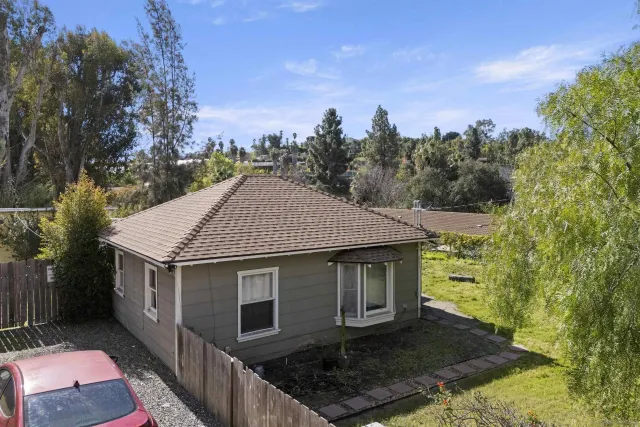 a aerial view of a house next to a yard