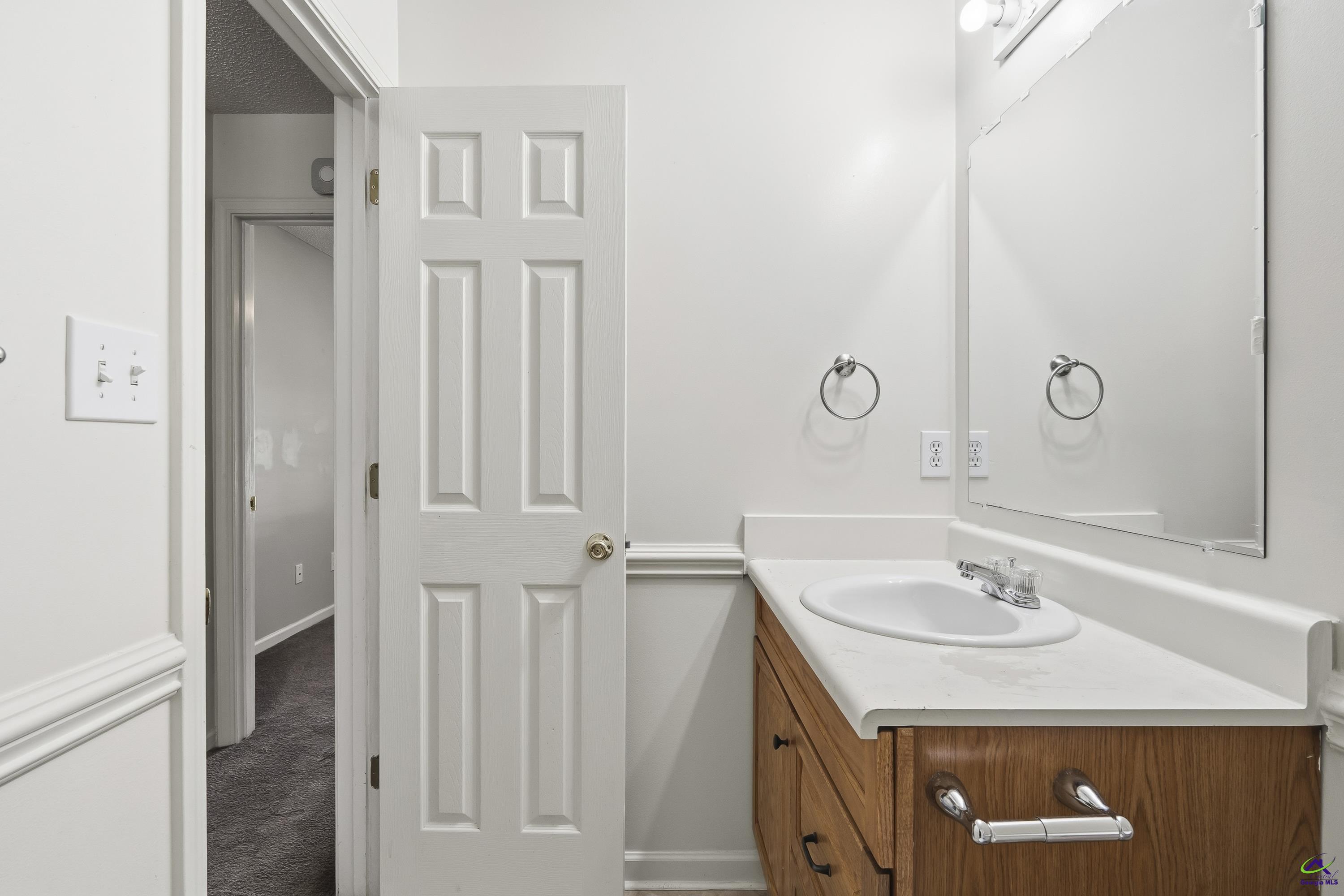 23 Breeze Point Byron, GA 31008 - Photo 23 of 38 a bathroom with a sink vanity and a mirror