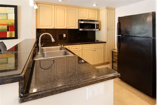 a kitchen with a refrigerator and a sink
