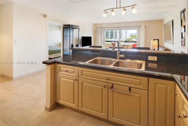 a kitchen with stainless steel appliances granite countertop a sink and a refrigerator
