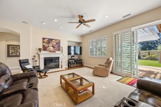 a living room with a fireplace and a flat screen tv