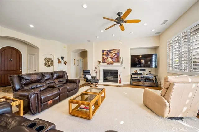a living room with furniture gym equipment and a view of kitchen