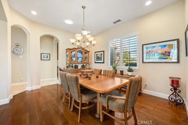 a kitchen with stainless steel appliances kitchen island granite countertop a refrigerator and a sink