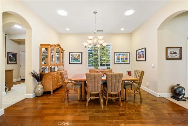 a kitchen with stainless steel appliances a stove a sink dishwasher and cabinets with wooden floor