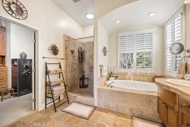 a bedroom with a bed and a flat tv screen on the dresser