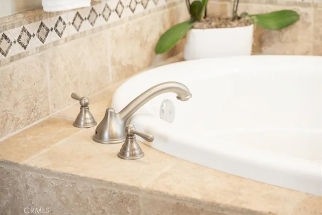 a bathroom with a granite countertop sink a mirror and a window