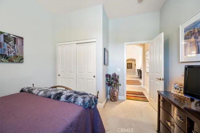 a view of a backyard with couches table and chairs and potted plants
