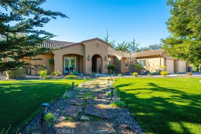 a front view of a house with garden