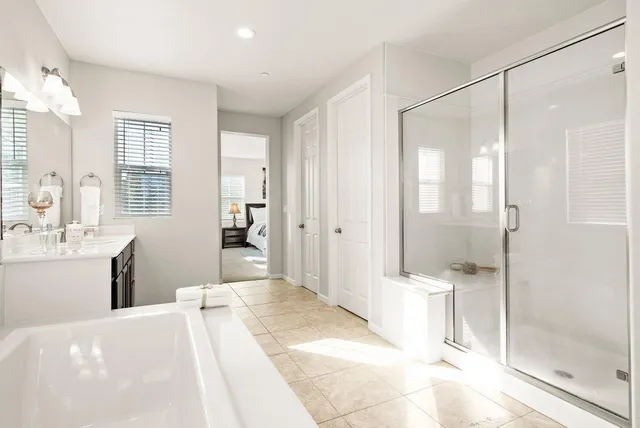 a bathroom with a tub shower and sink