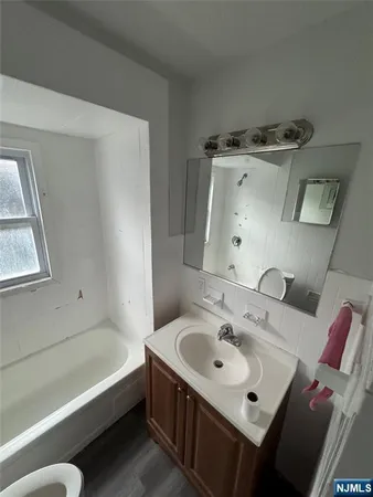 a bathroom with a toilet and a mirror