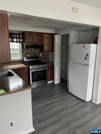 a kitchen with a refrigerator and a stove