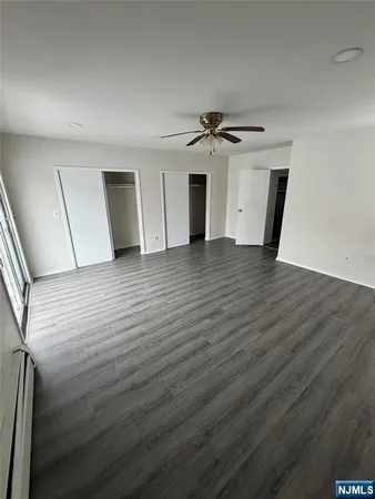 a view of hallway with wooden floor