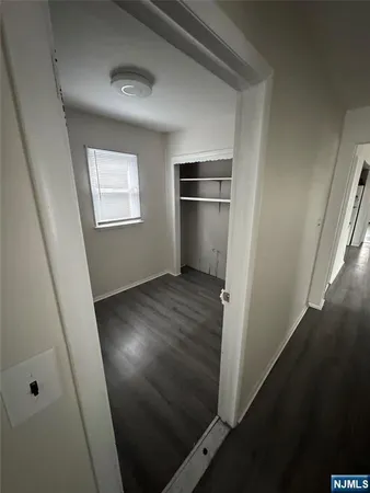 an empty room with wooden floor