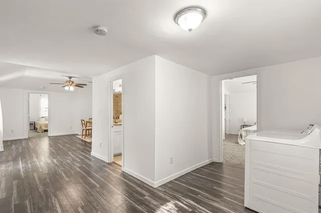 a view of a room with wooden floor and white walls