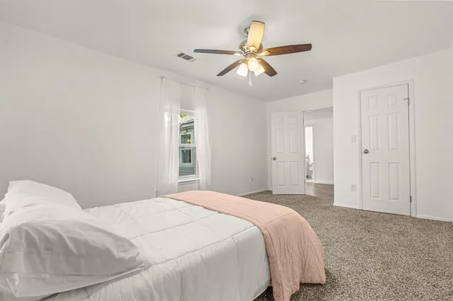 a bedroom with a large bed and closet
