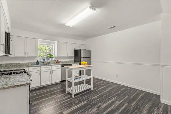 a kitchen with table and chairs in it