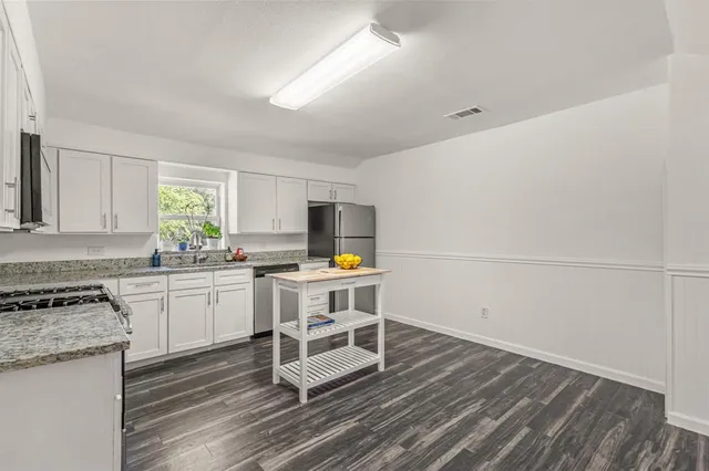 a kitchen with table and chairs in it