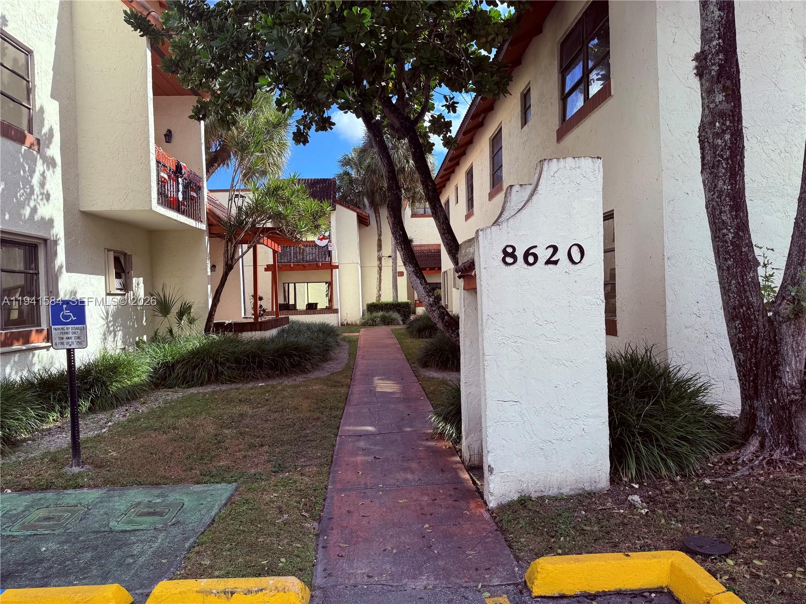 a view of a street with palm trees