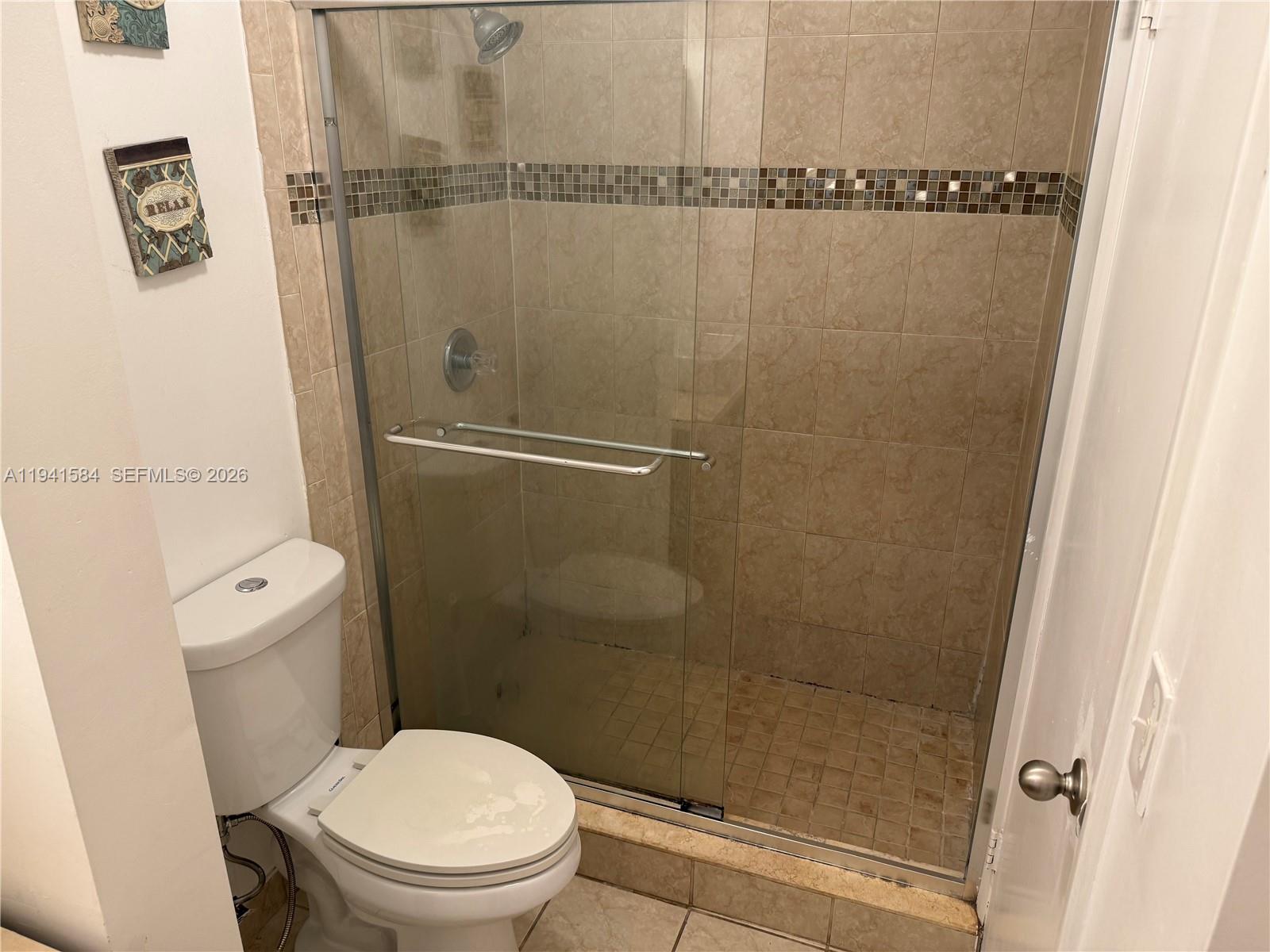 8620 Southwest 149th Avenue, Unit 416 Miami, FL 33193 - Photo 12 of 21 a bathroom with a shower and a toilet