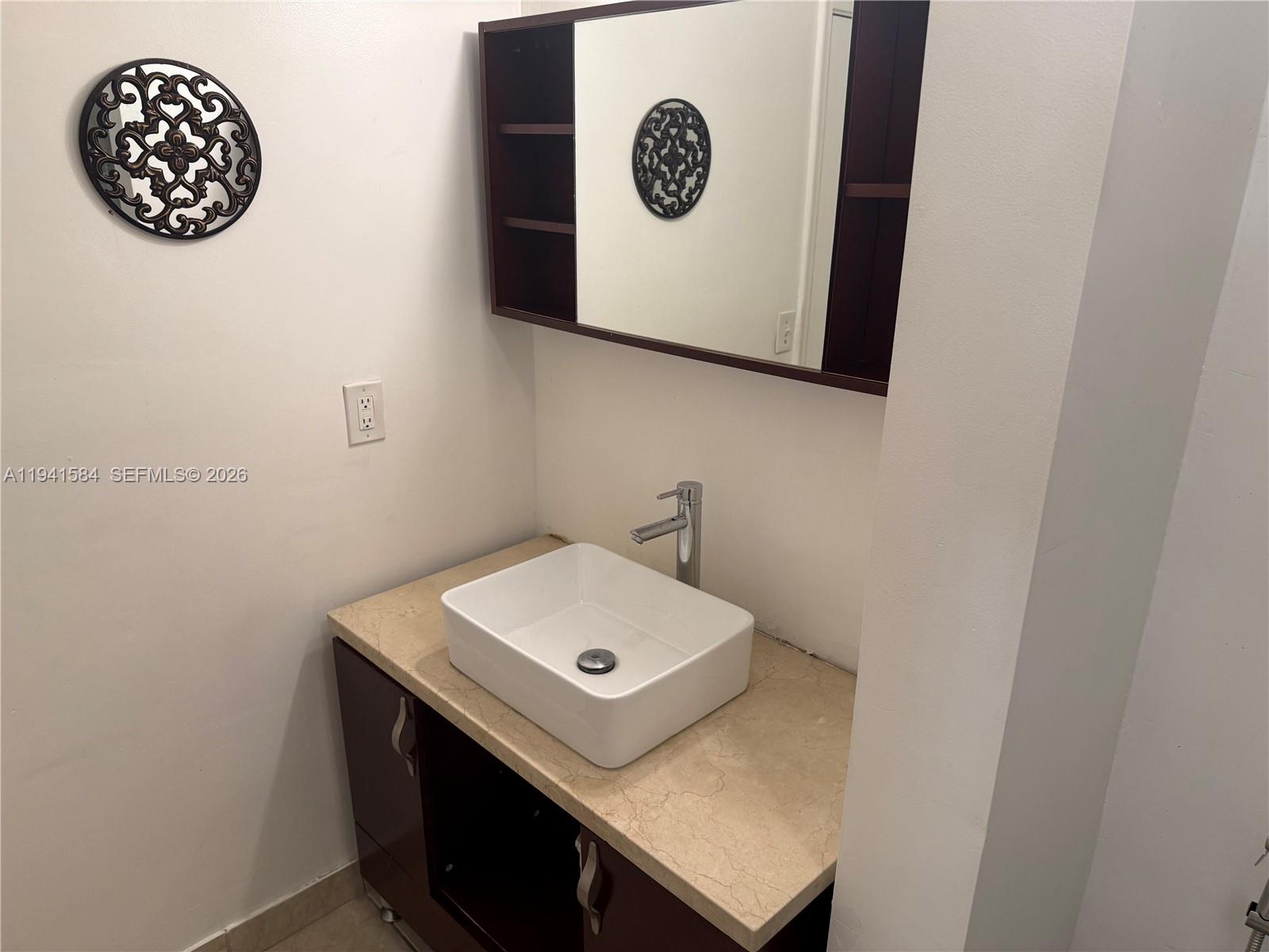 8620 Southwest 149th Avenue, Unit 416 Miami, FL 33193 - Photo 14 of 21 a bathroom with a sink and a mirror