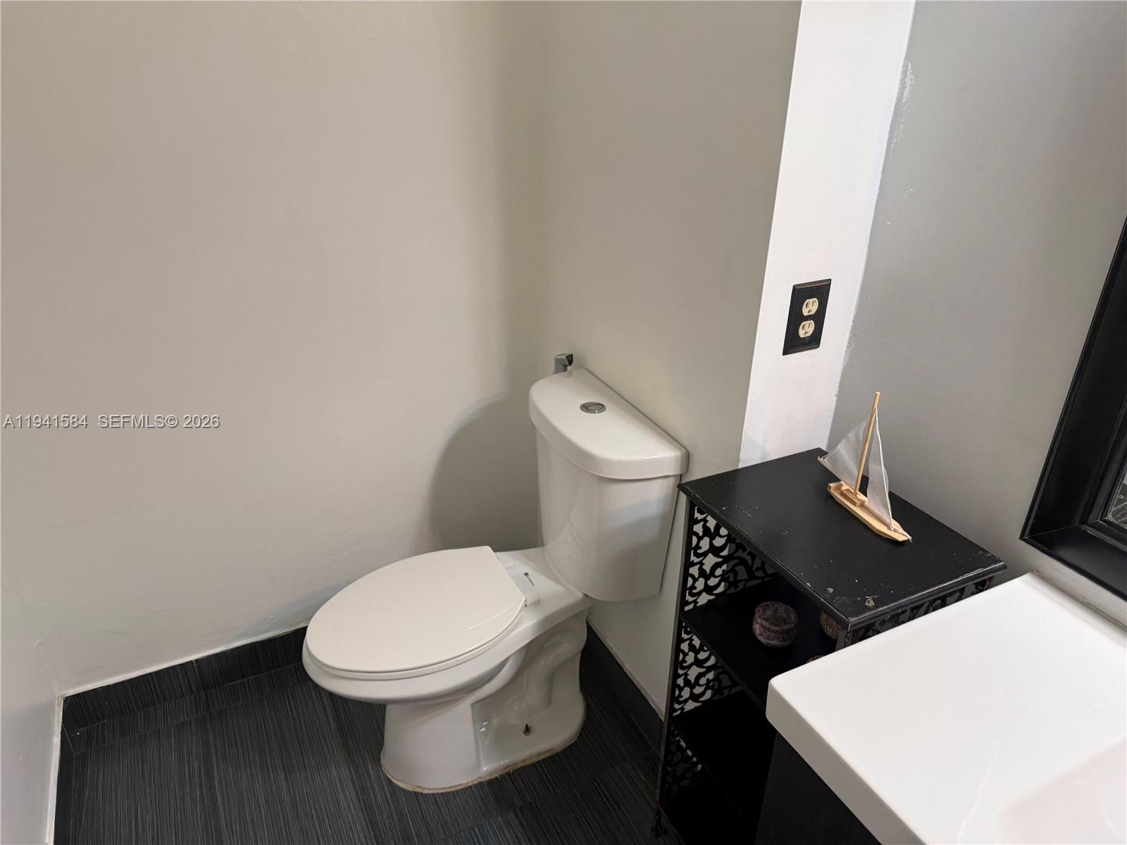 8620 Southwest 149th Avenue, Unit 416 Miami, FL 33193 - Photo 16 of 21 a bathroom with a toilet and a sink