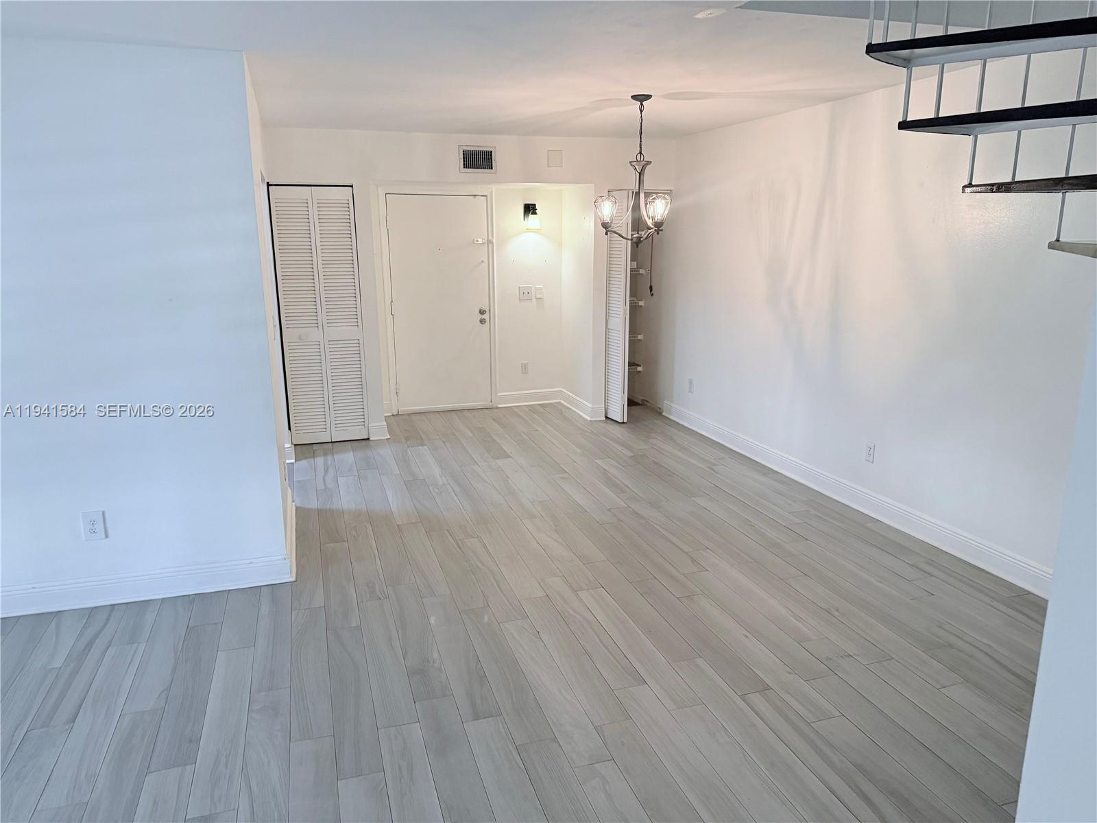 8620 Southwest 149th Avenue, Unit 416 Miami, FL 33193 - Photo 3 of 21 an empty room with wooden floor and a ceiling fan