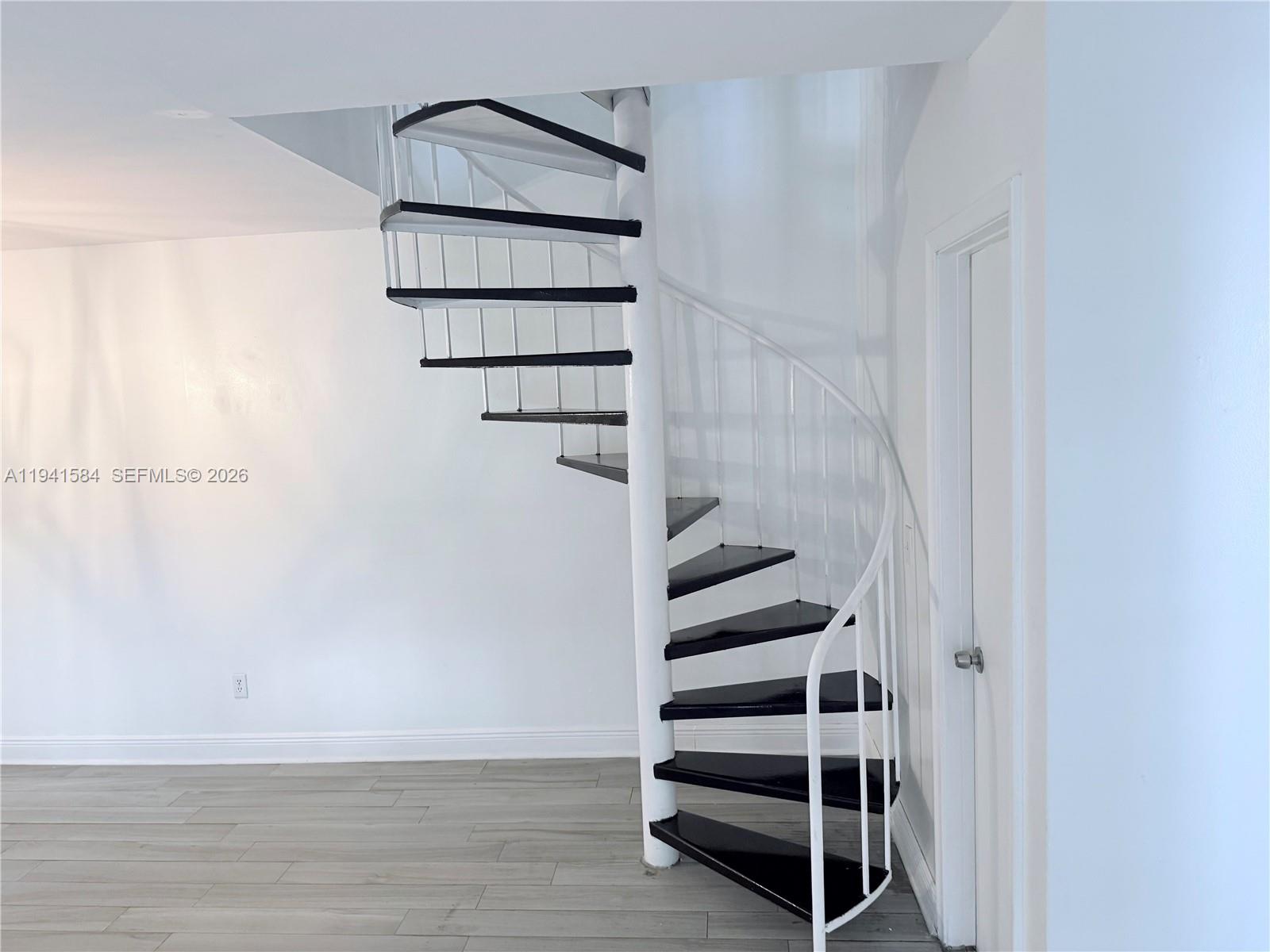 8620 Southwest 149th Avenue, Unit 416 Miami, FL 33193 - Photo 4 of 21 a view of staircase with white walls and a window