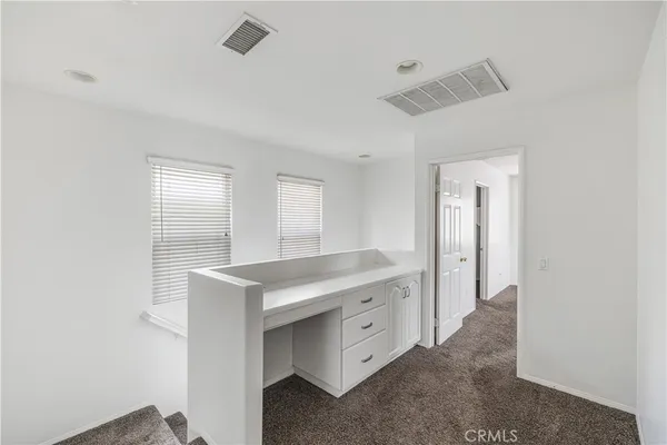 a hall with cabinets and window