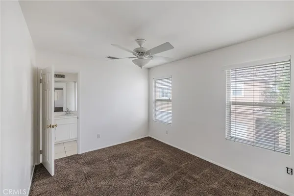 a view of a livingroom with a ceiling fan and window