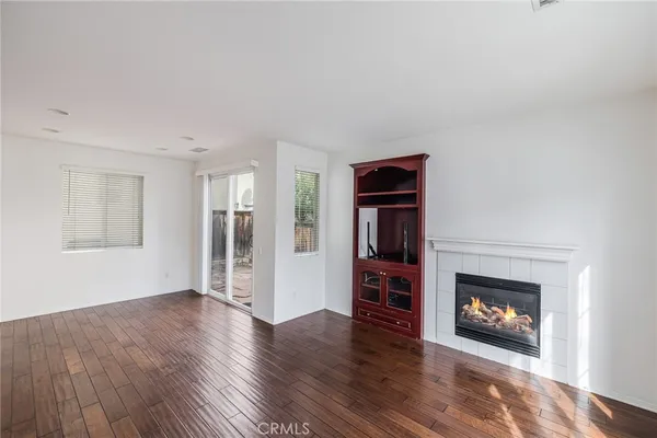a view of an empty room with window and fire place
