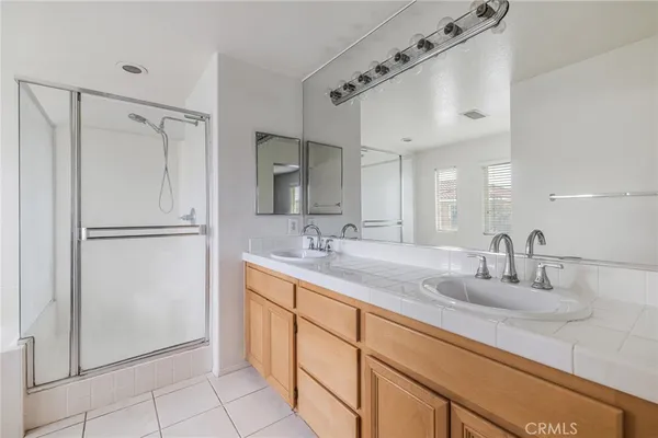 a bathroom with a double vanity sink and mirror