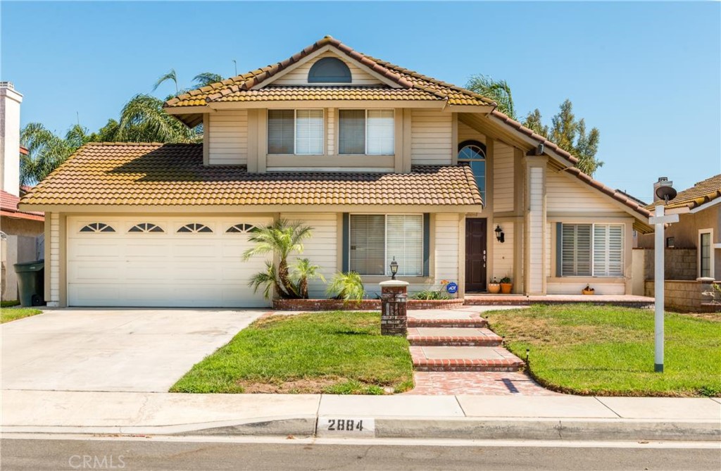 2884 East Big Range Road Ontario, CA 91761 - Photo 1 of 1 a front view of a house with a yard and garage