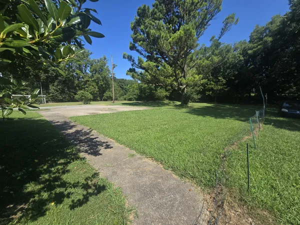 a view of a street with a yard