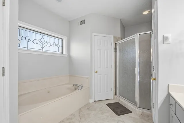 a bathroom with a bathtub and a shower