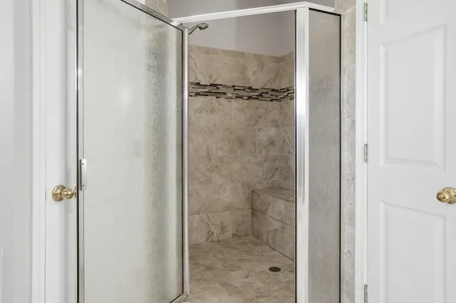 a bathroom with a glass shower door