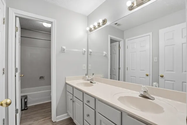 a bathroom with a double vanity sink and a mirror