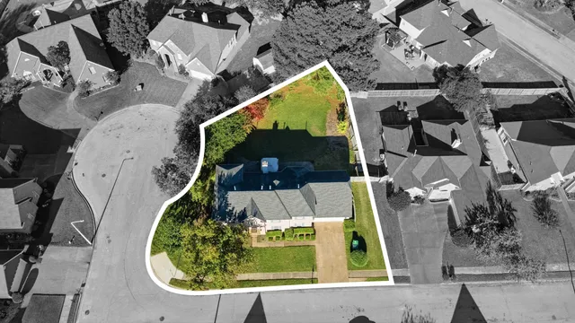 an aerial view of a house with a swimming pool