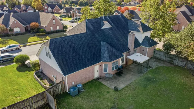 an aerial view of a house with garden space and street view