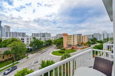 a balcony with outdoor seating and plants