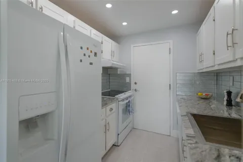 a kitchen with cabinets and a stove