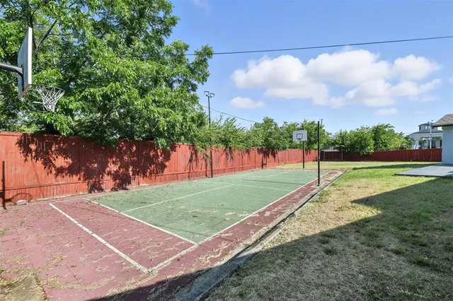 a view of a park and a large trees