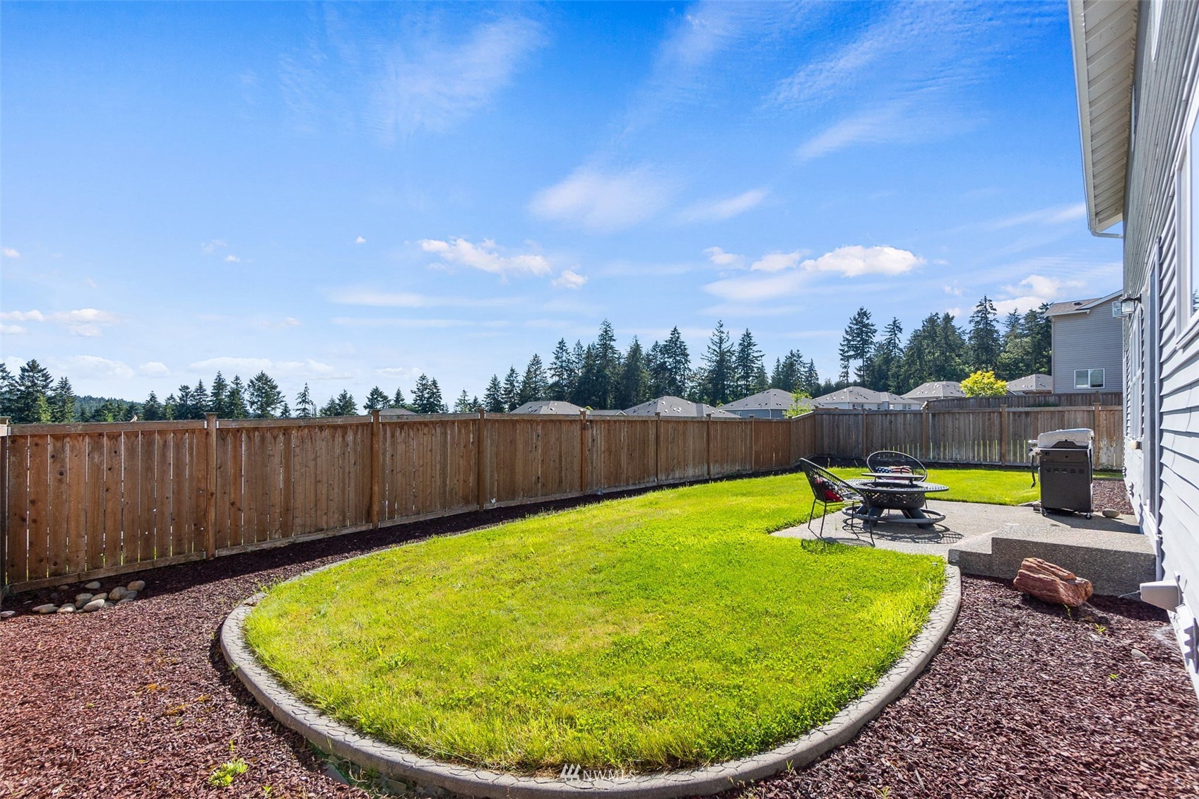 1175 Swan Loop DuPont, WA 98327 - Photo 31 of 33 a view of a swimming pool with a patio and wooden fence