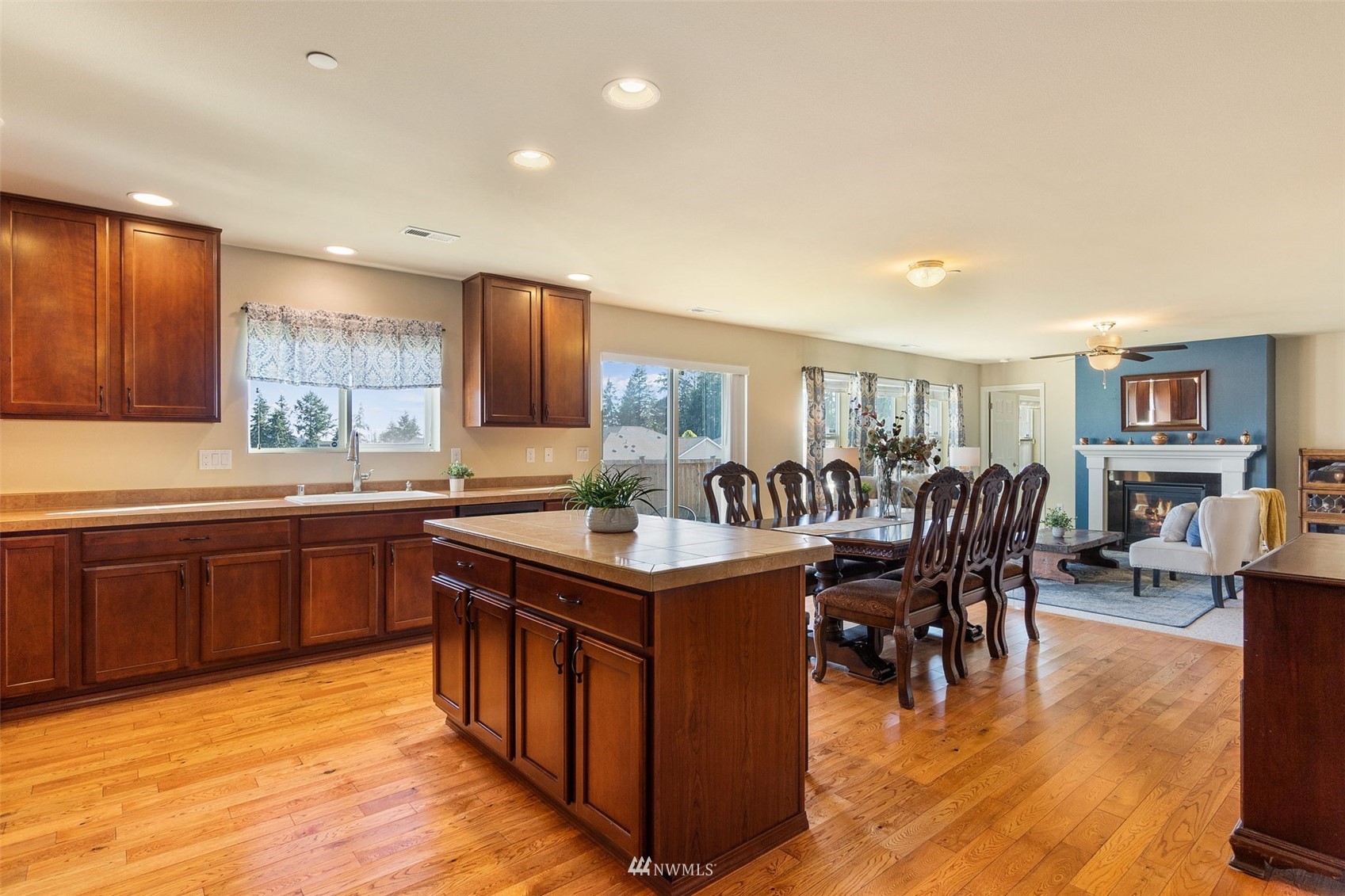 1175 Swan Loop DuPont, WA 98327 - Photo 8 of 33 a kitchen with stainless steel appliances granite countertop a table and chairs in it